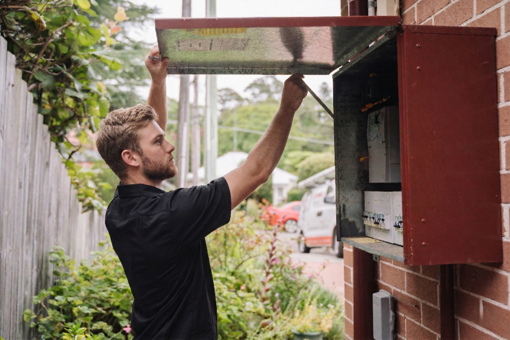 Electrician installing downlights in a Caringbah home